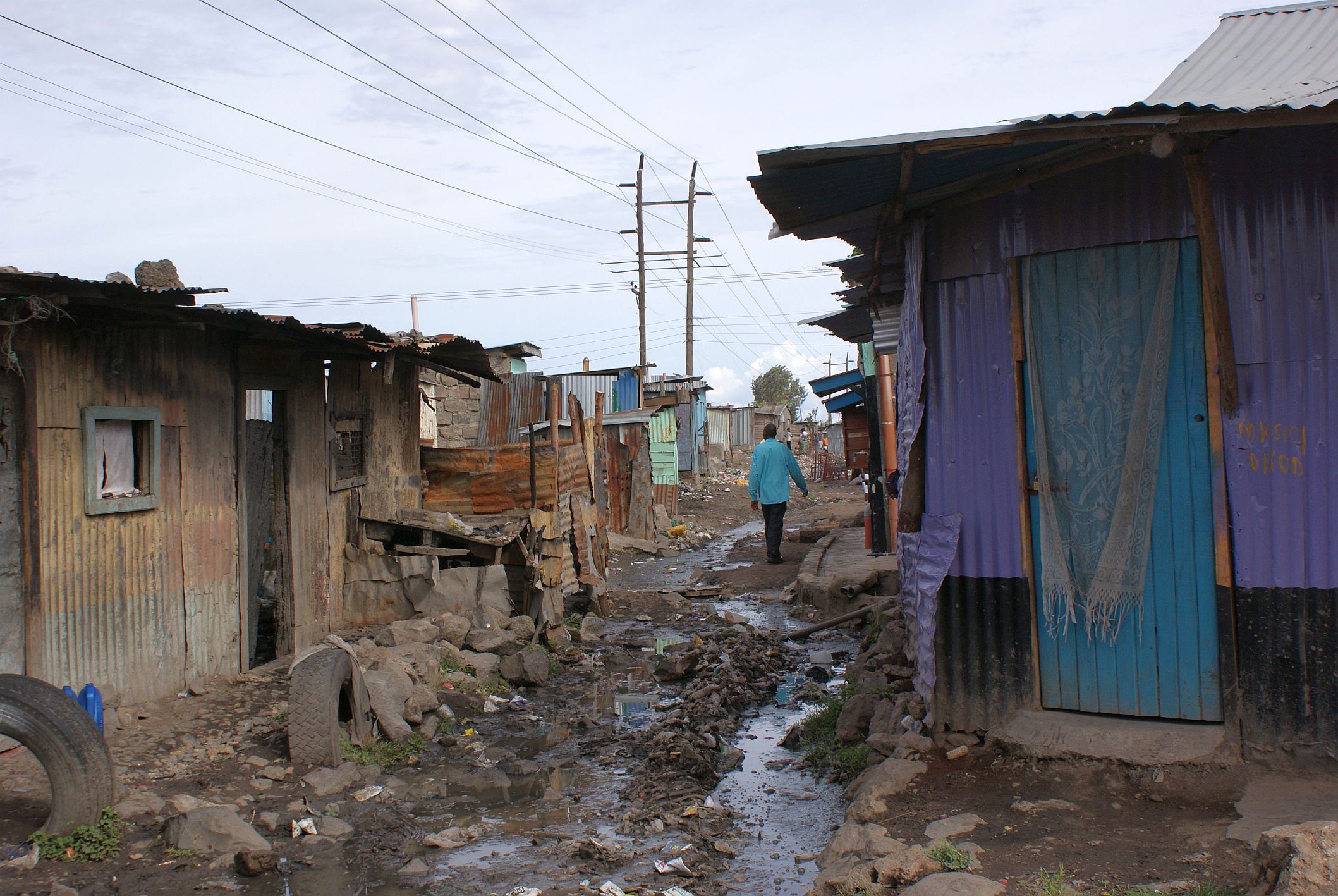 Slum in Nairobi_Kenya Man walking in a slum in Nairobi, Kenya