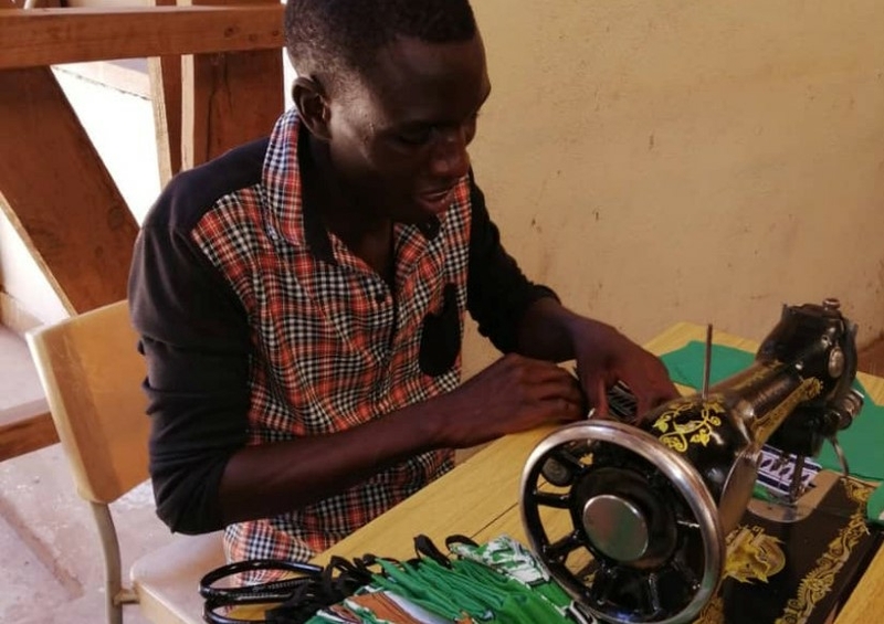 Youth tailor producing masks in Malawi. Youth tailor producing masks in Malawi.