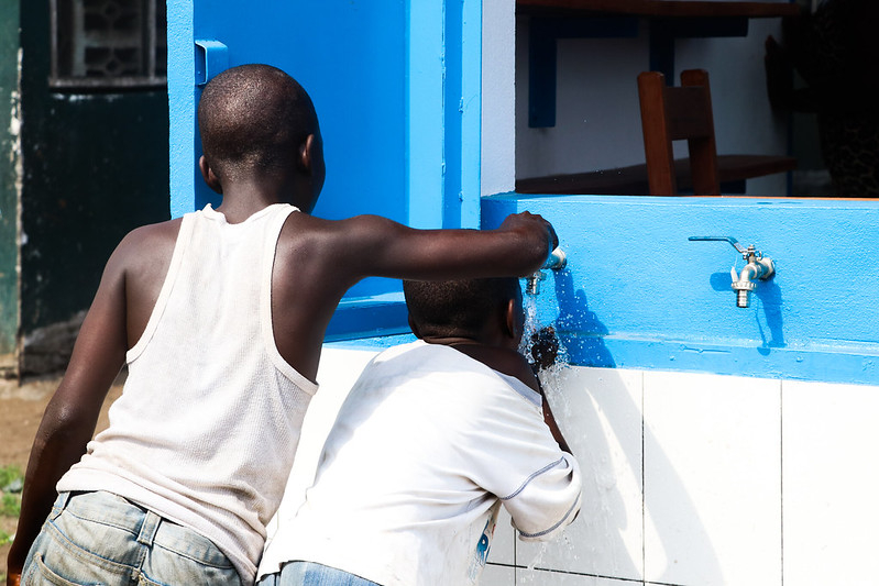 Boys in Liberia at a water kiosk built by Cities Alliance