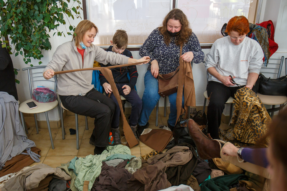 People rip the pieces of fabric to make camouflage nets for Ukrainian defenders, Uzhhorod, Zakarpattia Region, western Ukraine. February 28, 2022. UKRAINFORM.