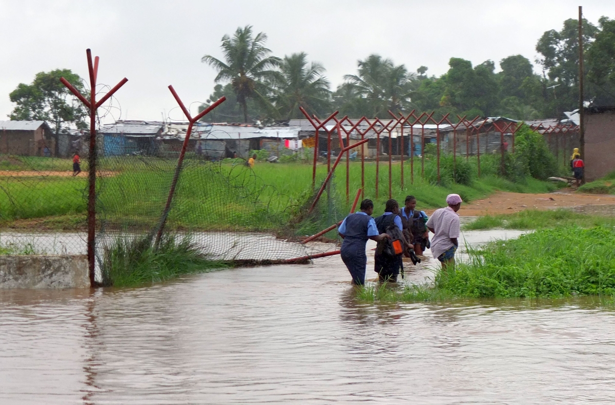 School girls walking in the floods, Monrovia, Liberia