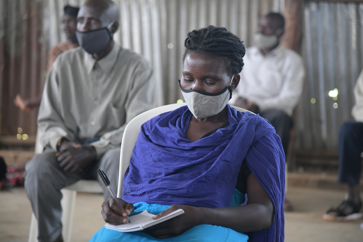 A participant takes notes during one of the AVSI business finance training sessions. _Photo Credit-KJE NOWO_AVSI.JPG