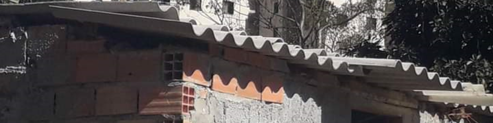 Banner_LandRegularizationinBrazil_Publication Brazil. In this picture, one can see the contrast between informal precarious housing in the front and building developments in the background