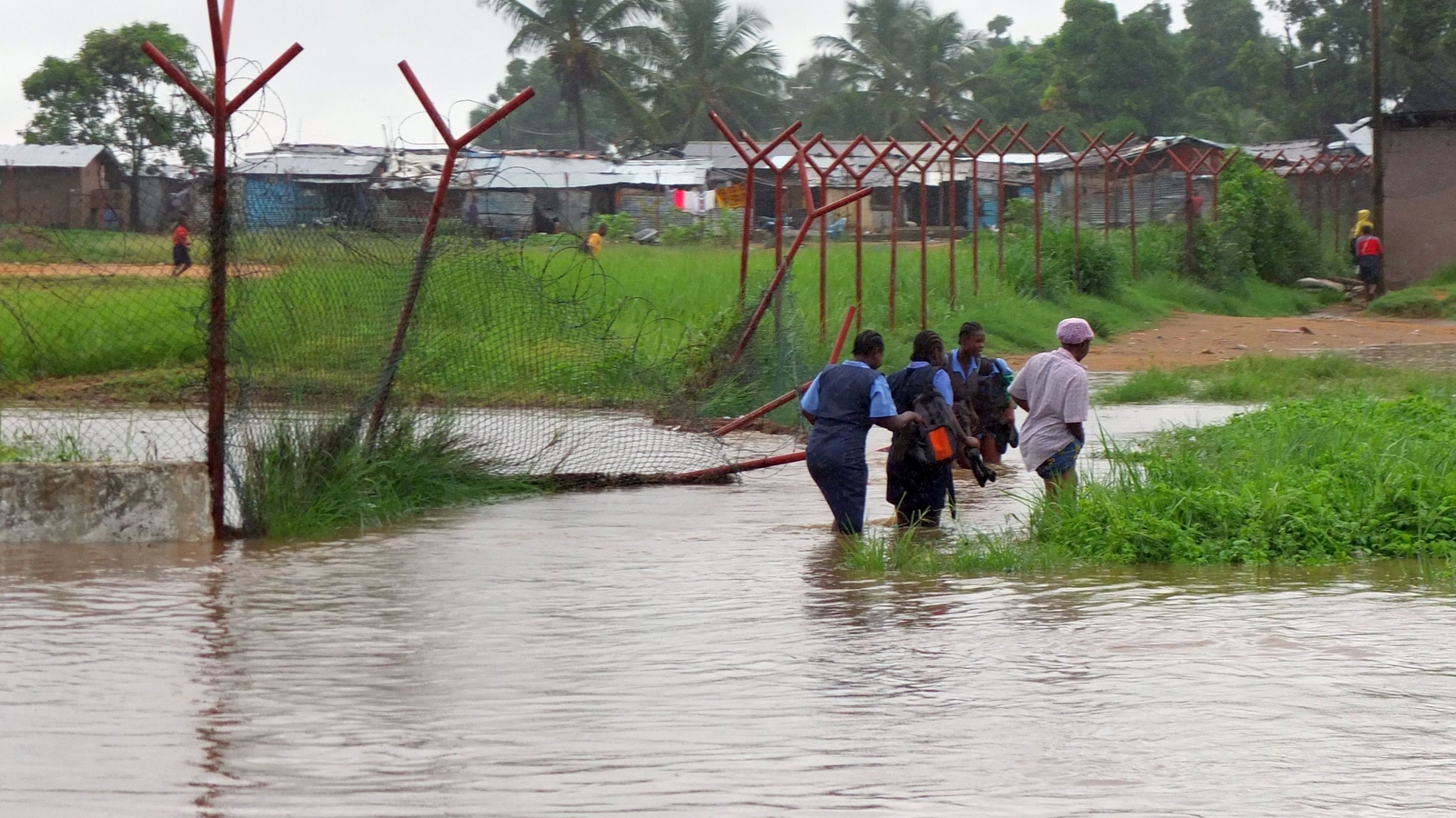 School girls walking in the floods, Monrovia, Liberia