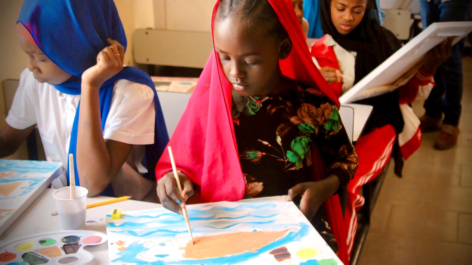 School girls painting during a climate awareness-raising activity. Sebkha, Mauritania